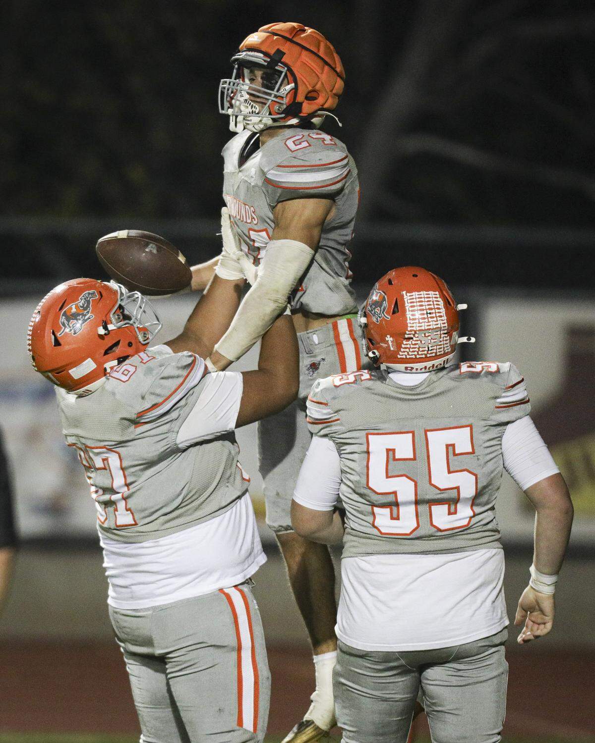 Max Rodriguez lifts Damon Mitchell after he scored a touchdown. Ryland King looks on. San Luis Obispo beat Atascadero 28-14 in high school football on Oct. 31, 2025.