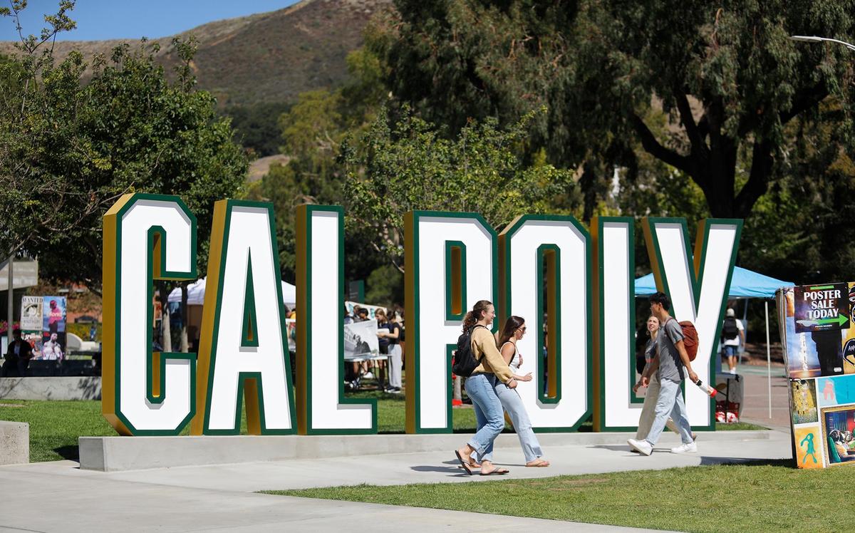 Students walk past the Cal Poly sign in the University Union on Sept. 24, 2024.