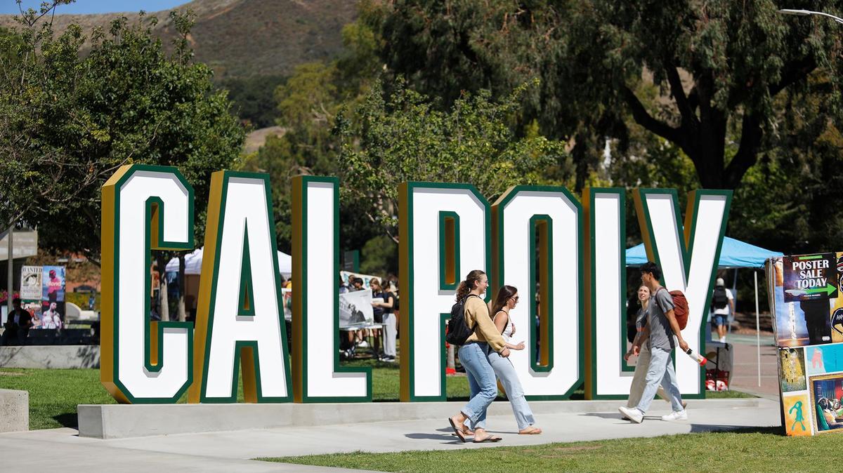 Students walk past the Cal Poly sign in the University Union on Sept. 24, 2024.