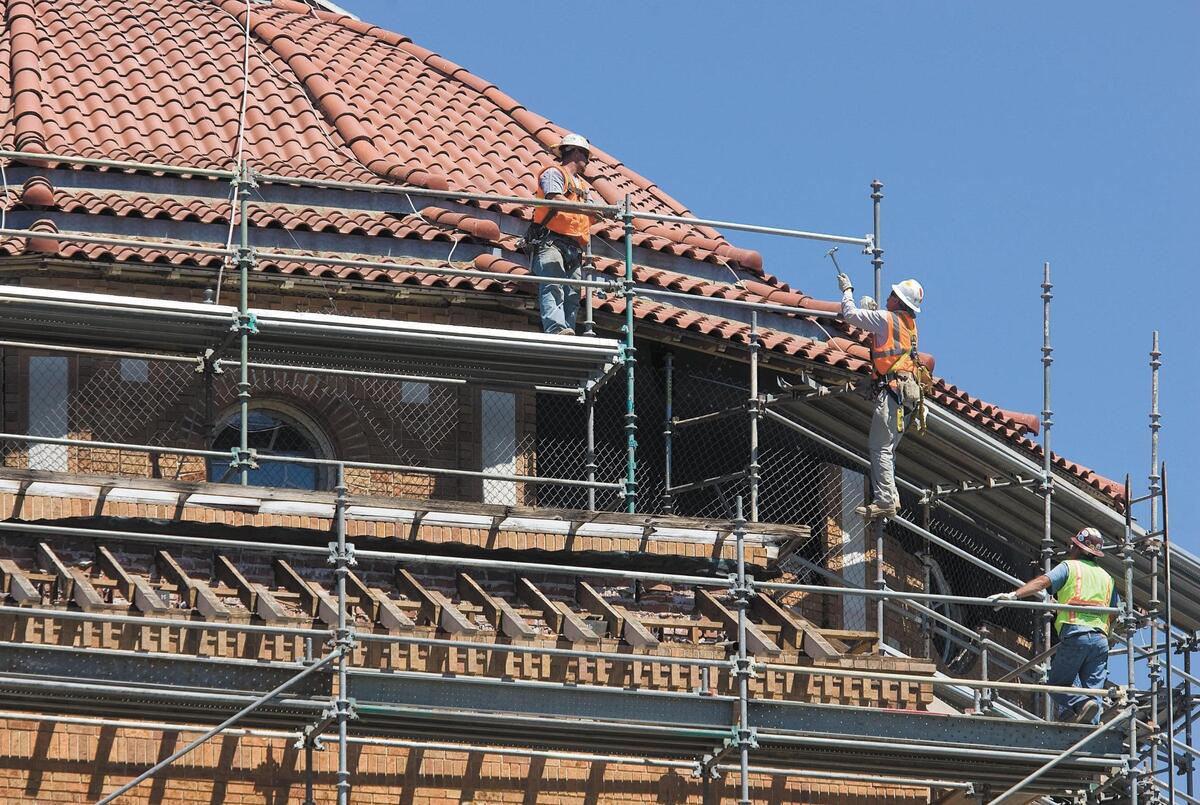 Workers assemble scaffolding around the rotunda of the historic Atascadero administration building. The reconstruction work on Sept. 8, 2011, was repairing damage from the San Simeon Earthquake.
