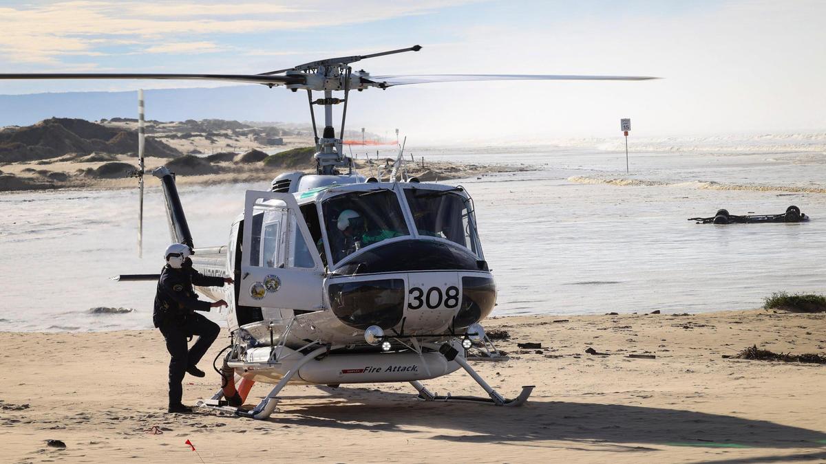 Santa Barbara County sent one of three helicopters for rescue assignments at Oceano Dunes SVRA Dec. 28, 2023. A truck that attempted to cross Arroyo Grande Creek is in background.