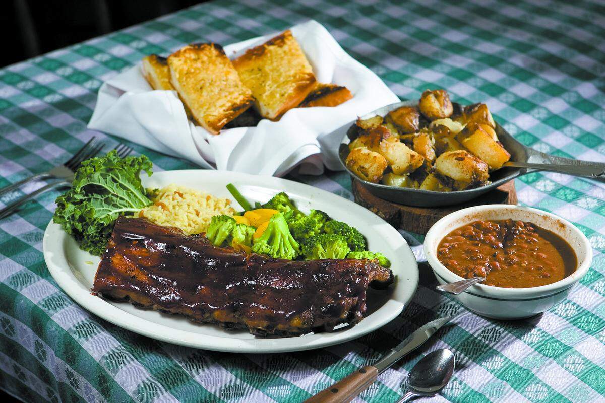 Every entree, like the baby back ribs, comes with cheese bread, trail camp beans and ranch-fried potatoes.