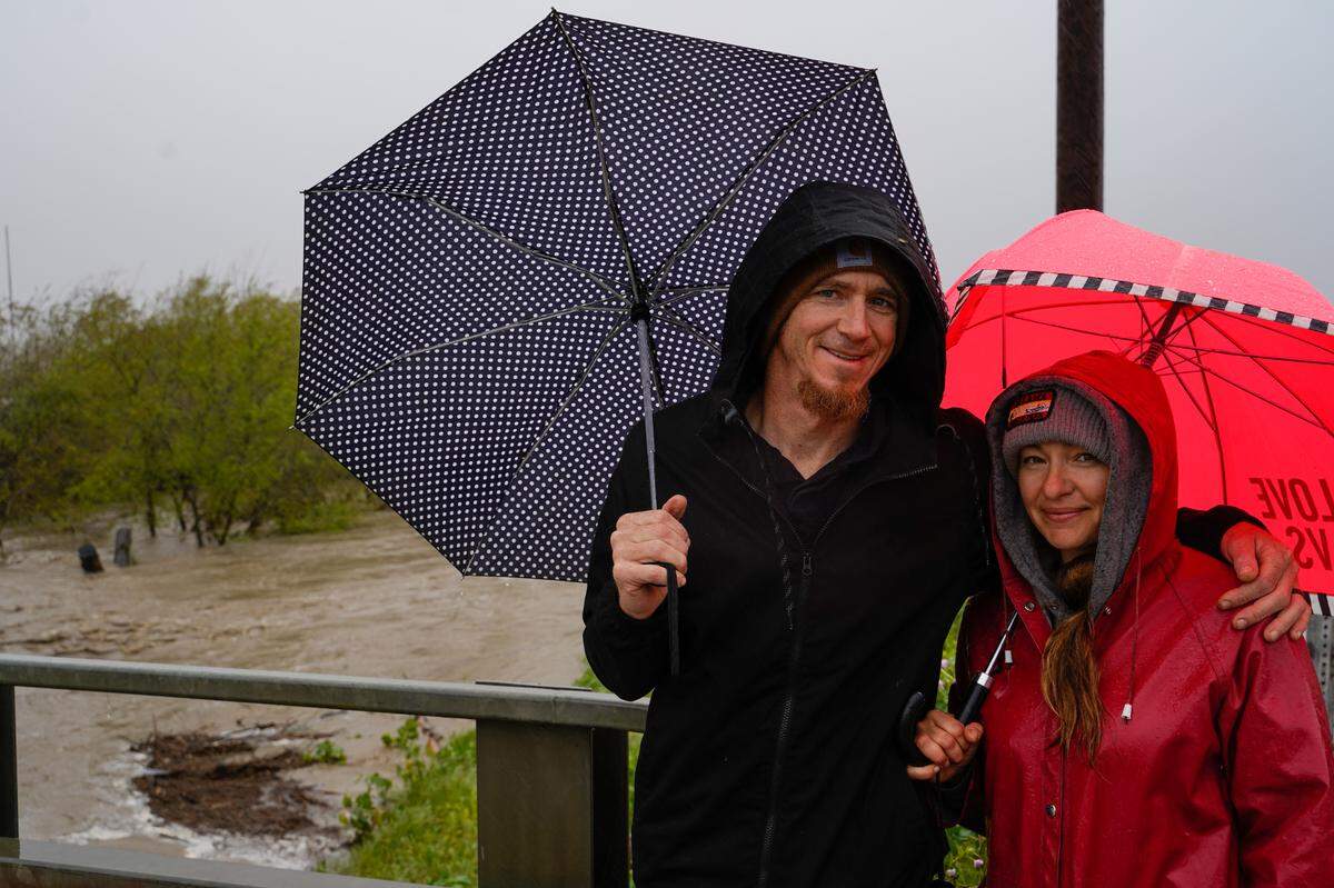 Phil and Chloe Chierhart, residents of the Pismo Sands Recreational Vehicle Resort, brought their son to see the filling Arroyo Grande Creek Levee that borders the south end of the RV park on March 10, 2023.
