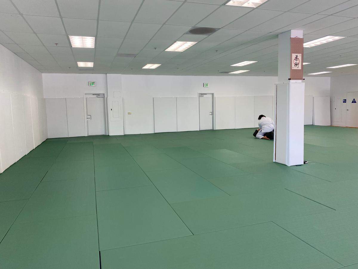 Members practice Brazilian jiu-jitsu on the 2,220 square foot mat at the new academy, Virtus, founded by retired Sergeants Melanie Franco and Eric Franco.