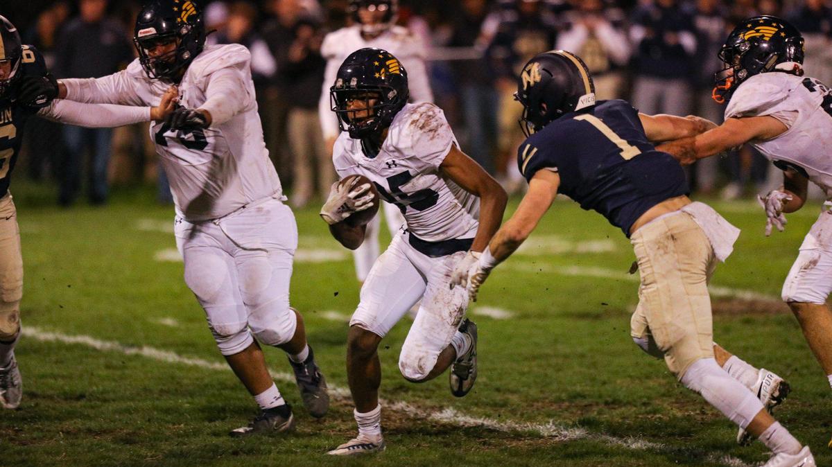 Arroyo Grande High’s Caleb Clark tries to elude a Mission Prep tackler in a CIF-Central Section football playoff game Nov. 10, 2022 . Clark returns for the Eagles as a junior this season, having accumulated 670 receiving yards, the top mark on the team, as a sophomore.