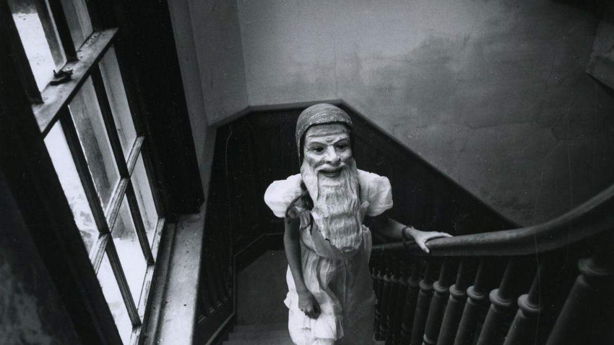 “Girl on Stairs With Mask”