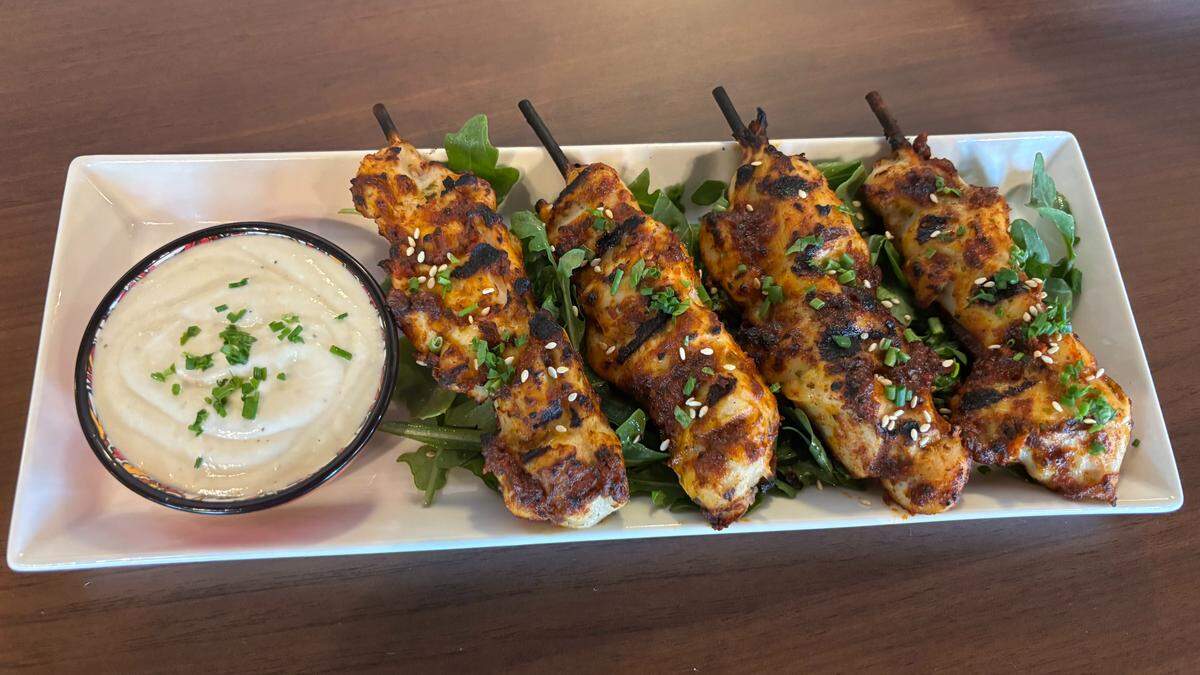 The Mabel Lounge’s menu includes small plates like the harrisa-honey chicken skewers. The Mabel Lounge in Atascadero opened on May 13 inside The Carlton Hotel, serving small bites and plates in a cozy, intimate atmosphere.