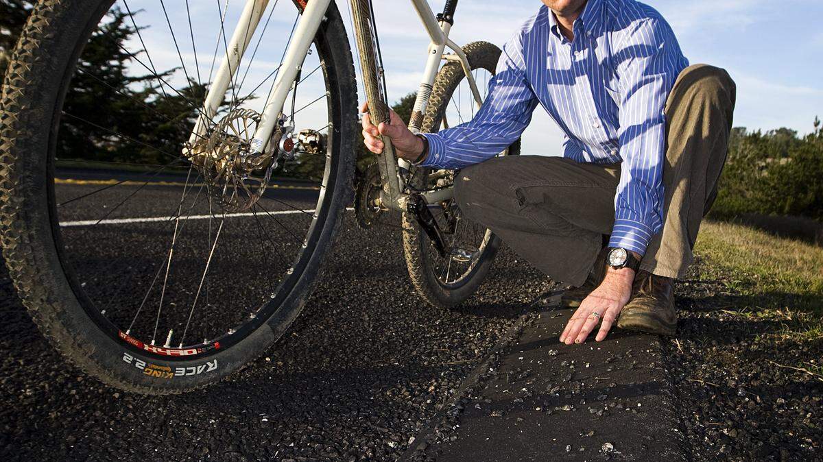 Linn’s restaurant general manager and avid bike rider Aaron Linn, on Monday, Jan. 7, points out some of the loose gravel that has riders on edge after a resurfacing job on Highway 1 north of Cambria which used a new, larger paving aggregate. In addition to the larger material, bike lanes in some parts have become narrower, drop-offs from the new paving to the old are sharp and potholes (some several inches deep) have been camouflaged by the repaving.