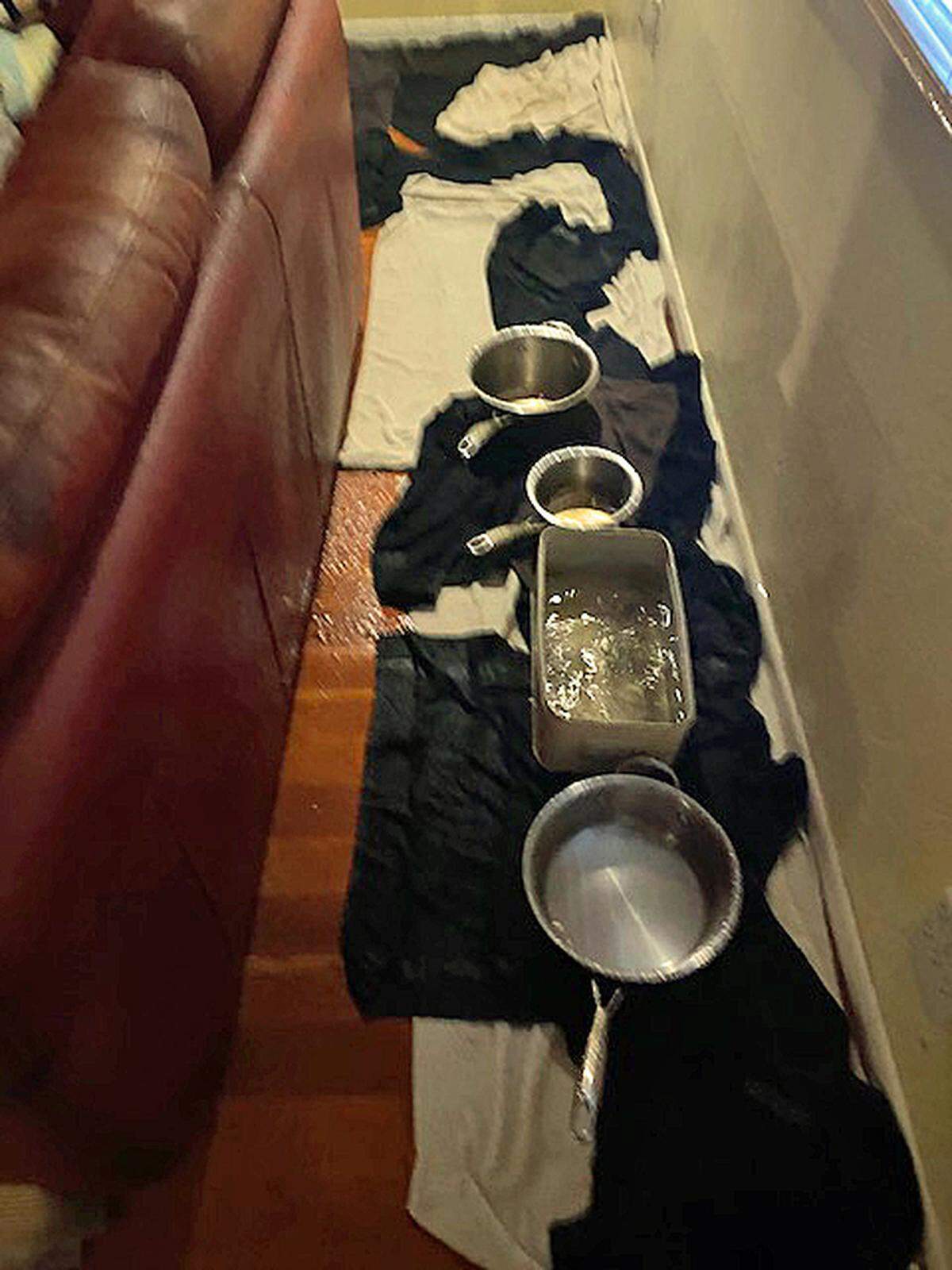 These pans and towels were just of a few of the emergency measures Ingrid and Andrew Turrey of Cambria used to try to stem indoor rainfall early Wednesday, Jan. 27, 2021, after strong storm winds lifted part of their Lodge Hill home’s roof. The leather couch also got soaked, as did most other things in the house.