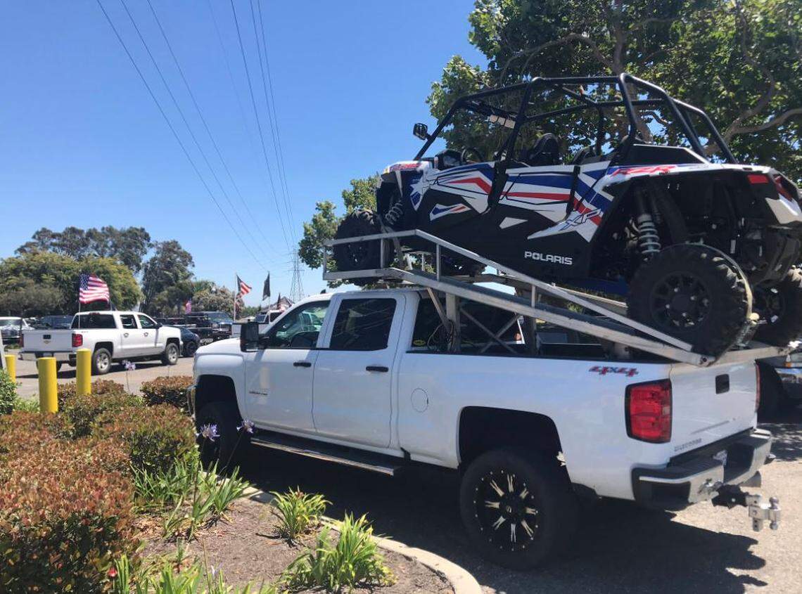 A truck with an ATV on the bed parked outside the California Coastal Commission’s meeting at the Embassy Suites in San Luis Obispo on Thursday.
