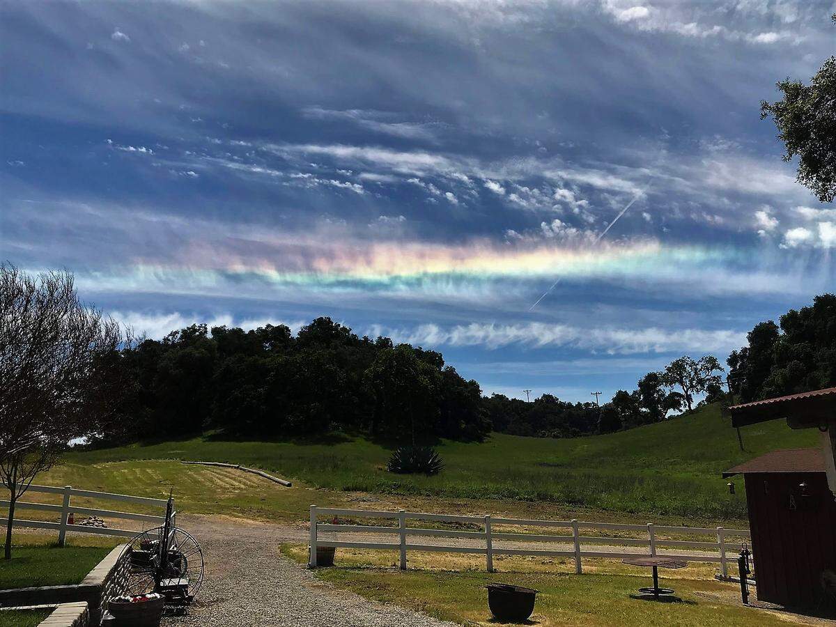 Caused by diffraction or the bending of the light waves through the ice crystals in cirrus clouds, a spectrum of colors produces circumhorizontal arcs much like the way that light passes through a prism.