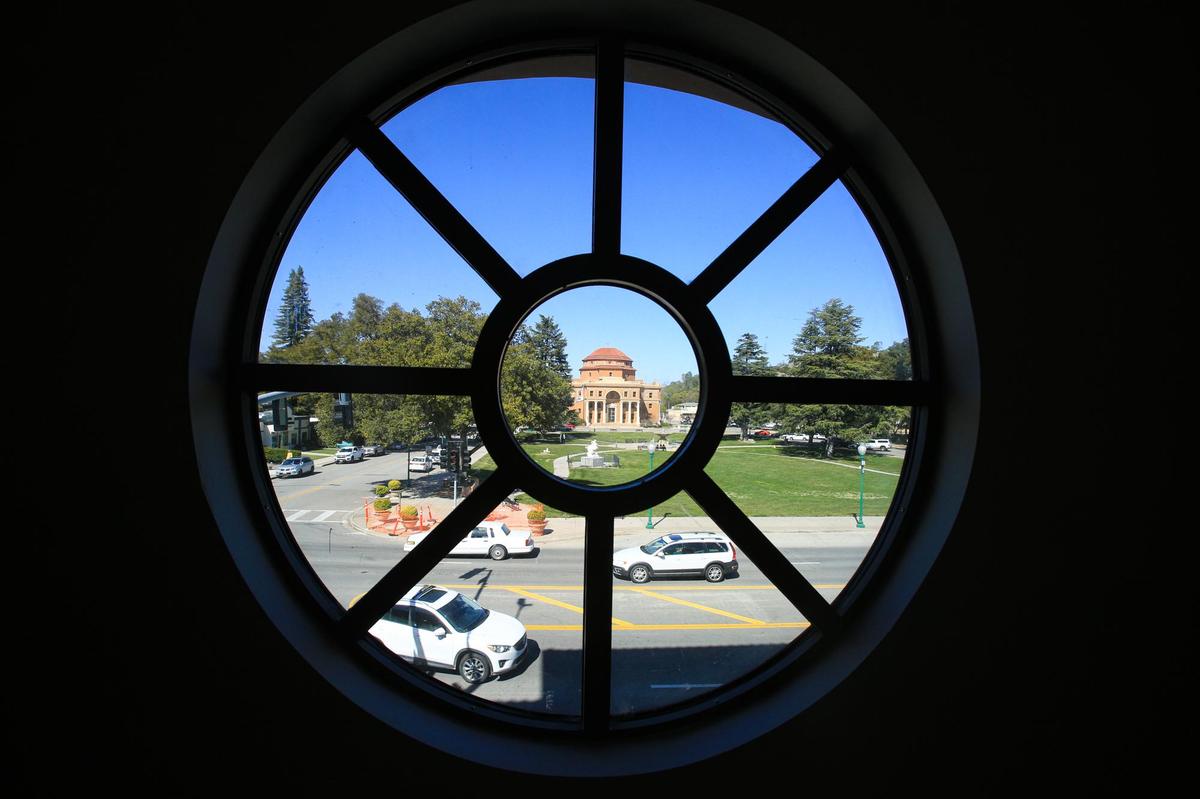 A circular window at the new La Plaza development frames Atascadero’s historic City Hall. The complex is in various stages of completion. It has commercial on the ground floor and residential units on the upper floors. It replaced a former gas station, an abandoned fast-food building and a vacant lot.