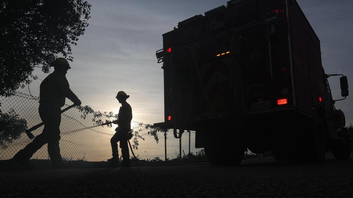 Ian Fremd, left and Kelby Jecker with Cayucos station of Cal Fire mop up along Mattie Road. A wind driven brush fire quickly moved south along Highway 101 along the Shell Beach straits and into Pismo Beach.