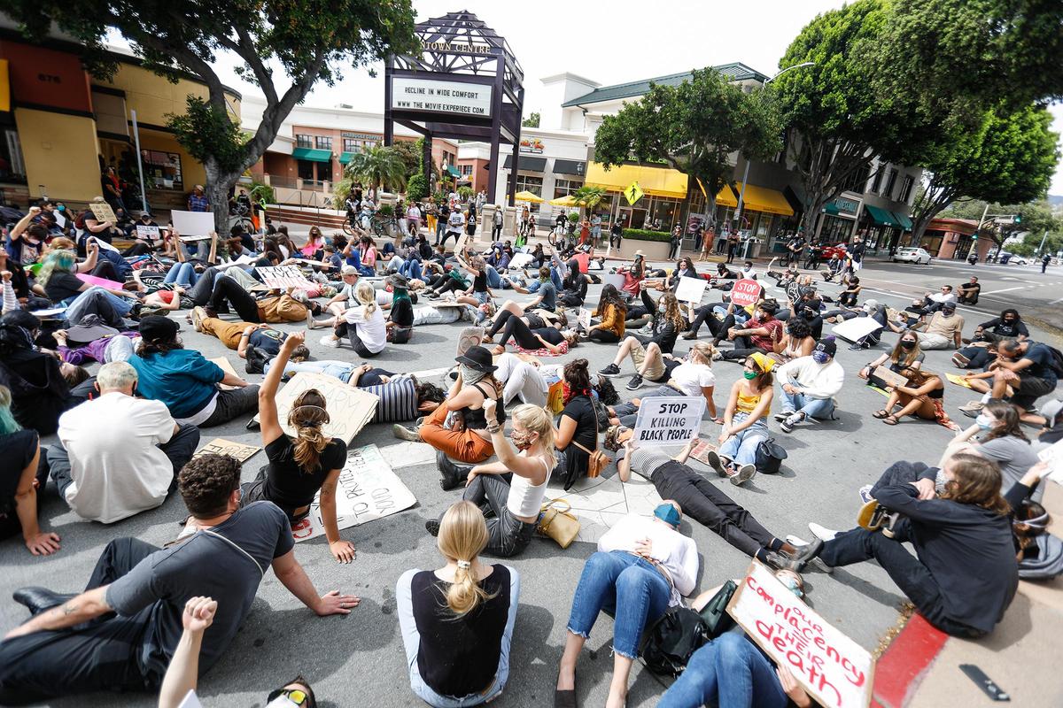 Marchers get down on the street on March Street in San Luis Obispo during a May 31, 2020, rally organized by RACE Matters SLO County to protest violence against people of color in America. The protest comes as numerous others pop up around the country in response to the death of black man, George Floyd, while in police custody in Minneapolis.