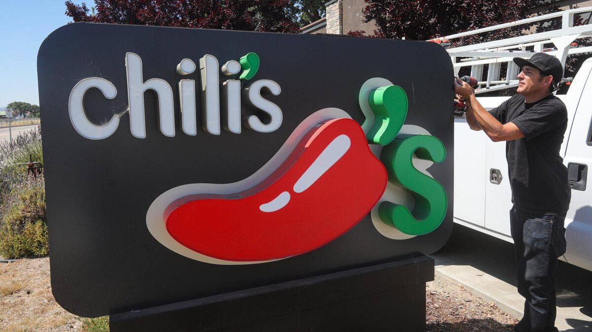 Rudy Walker with J. Walker Signs removes signage from a former Chili’s location in the Paso Robles shopping center with Ross and Target. The work took place June 28, 2023.