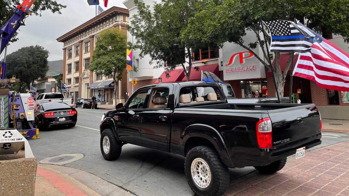 A caravan of vehicles drives through San Luis Obispo ahead of a vigil to honor slain Detective Luca Benedetti on Friday.