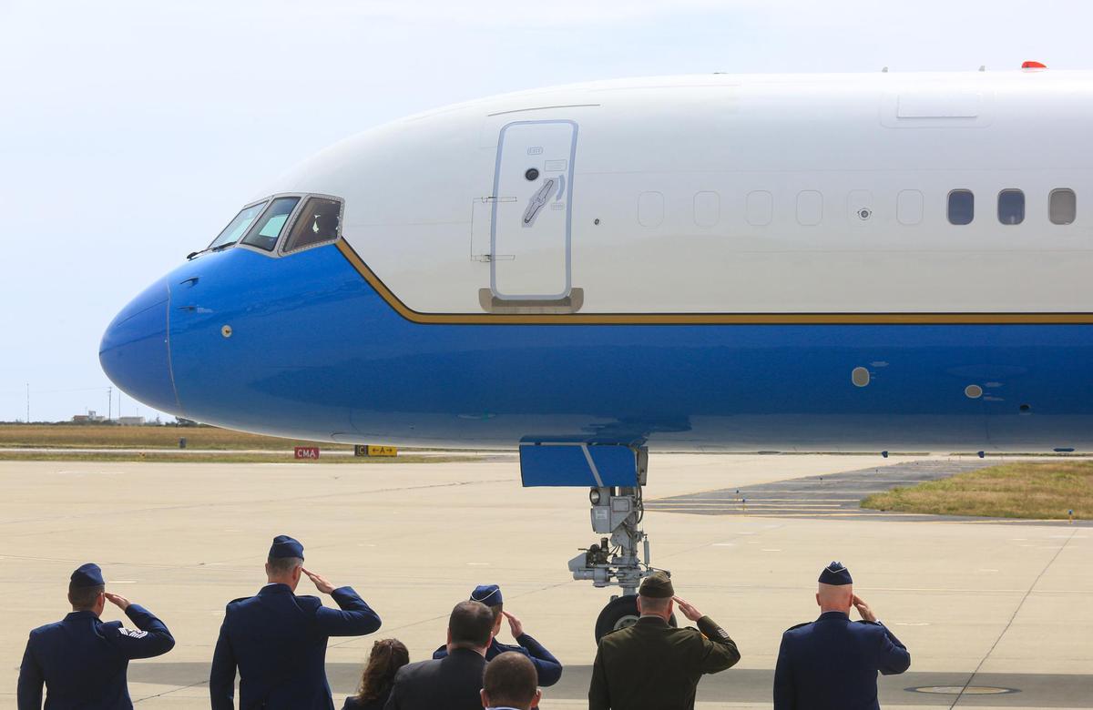 Service members salute as Air Force 2 taxies to a stop.