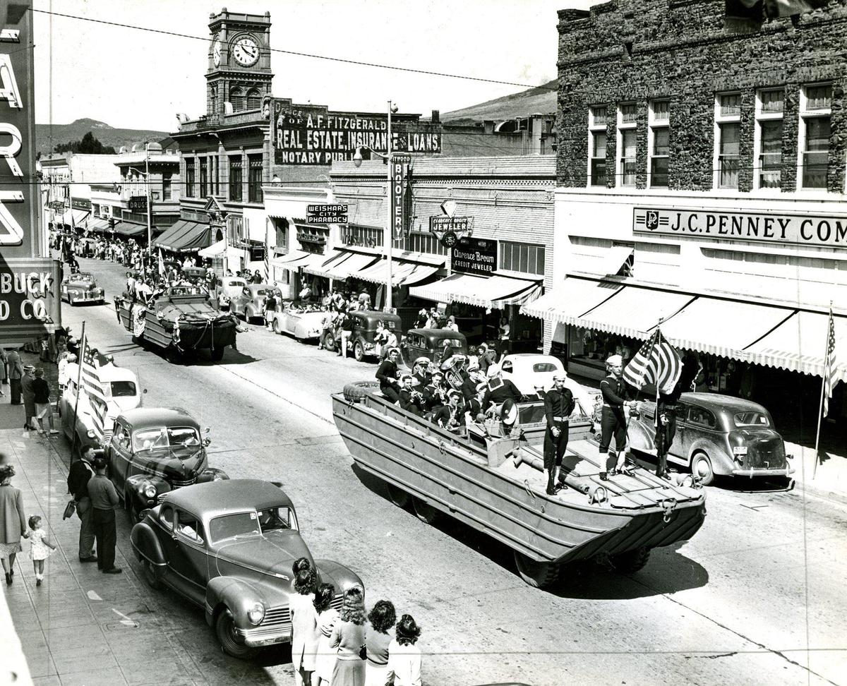 A parade with amphibious vehicles in downtown San Luis Obispo circa 1945 on Higuera Street with Sears and J.C. Penny buildings and the Warden Building clock tower.