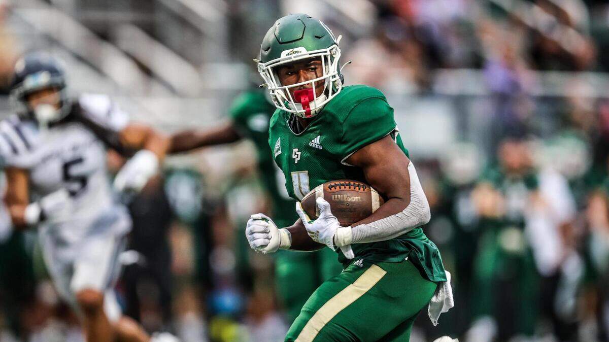 Cal Poly running back Mark Biggins (4) scored his first career touchdown against the University of San Diego on Sept. 1, 2023. 