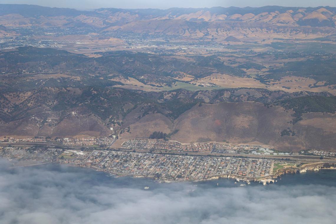 Highway 101 runs through Shell Beach in the foreground, while Dinosaur Caves Park can been seen at the lower right of the photo. The Santa Lucia Range is in the distance. The Northern Chumash Tribal Council organized an aerial tour of lands bordering the Chumash Heritage National Marine Sanctuary on Sept. 18, 2024. The flight was sponsored by EcoFlight, a nonprofit dedicated to appreciation of the environment.