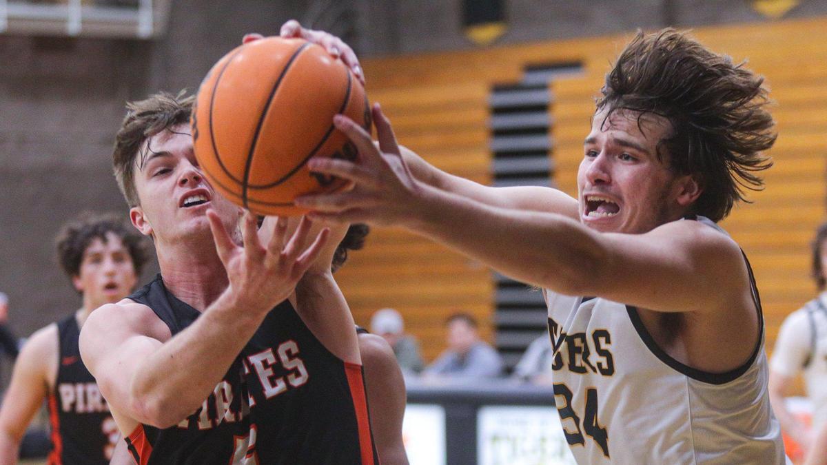 Caleb Cassidy (5) and James Machado (34) battle for a rebound in San Luis Obispo’s 63-51 win over Santa Ynez in a boy’s basketball game on Jan. 20, 2023.