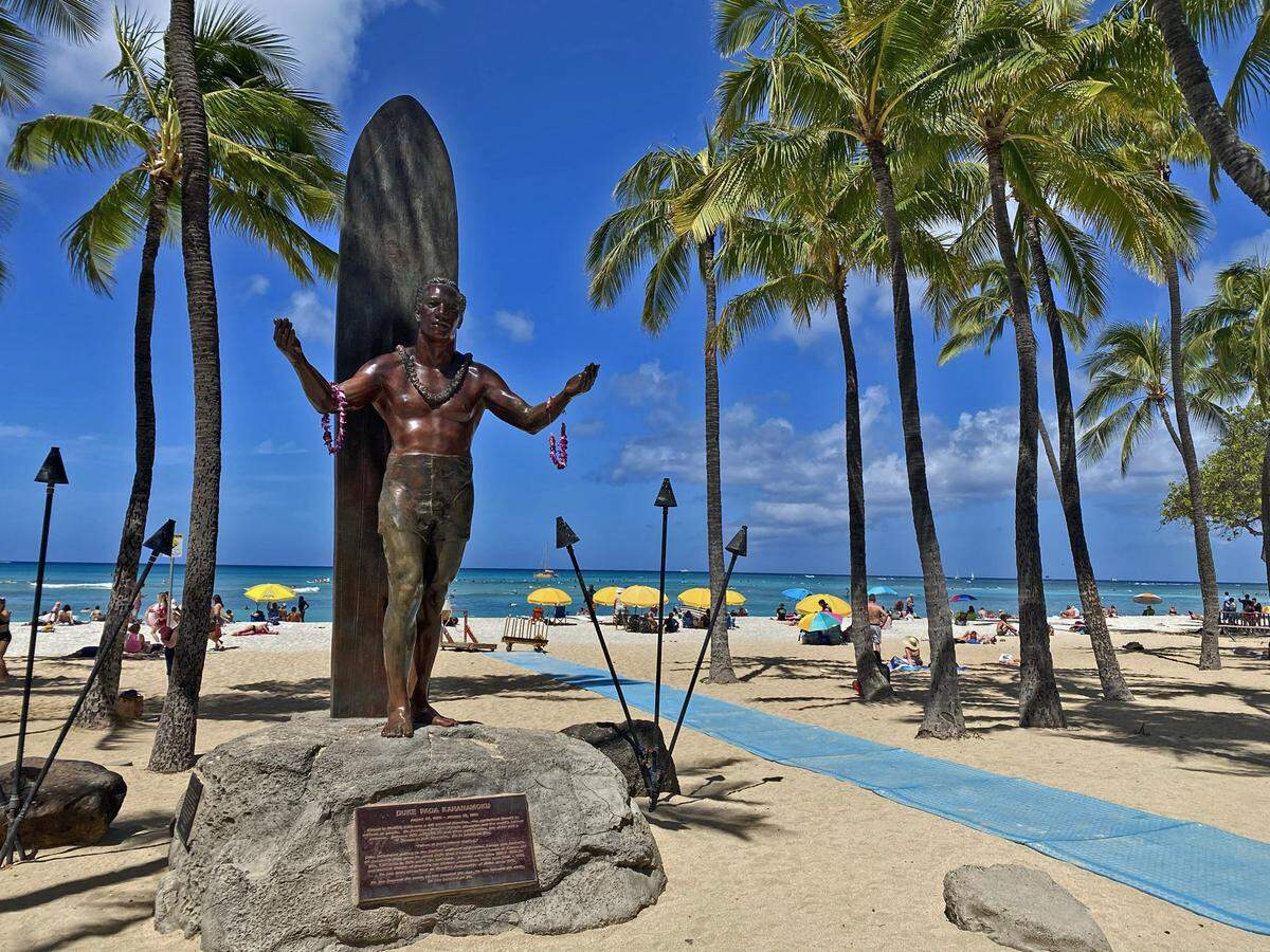 A statue of legendary surfer Duke Kahanamoku greets visitors to Wakiki Beach in Honolulu, Hawaii.