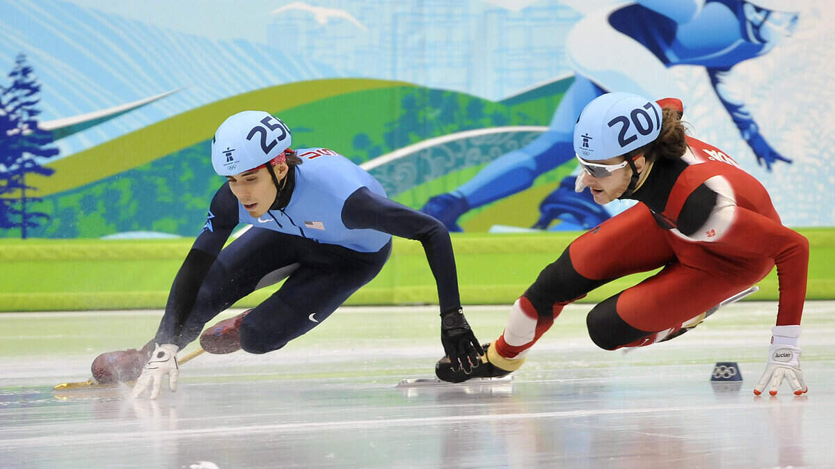 Jean Olivier of Canada, right, battles for the lead with Apolo Ohno of the U.S. in the men's 500-meter short track speed skating qualifying heat. (Jenelle Schneider/Canwest News Service/MCT)