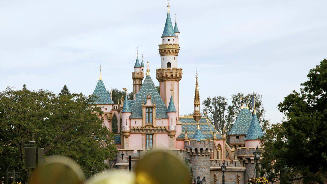 In this Jan. 22, 2015 file photo, visitors walk toward Sleeping Beauty’s Castle at Disneyland Resort in Anaheim, Calif. Disney officials announced Thursday that the park will begin selling alcohol for the first time in 63 years when Star Wars: Galaxy’s Edge opens in 2019.