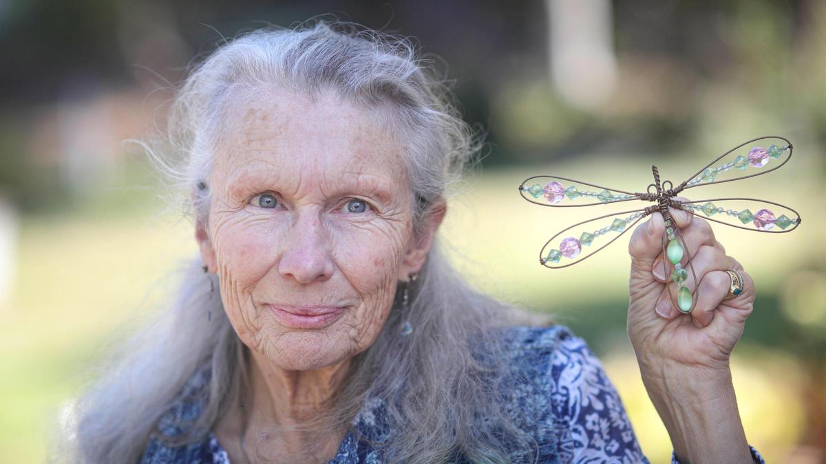 Dawn Marie Anderson holds dragonfly artwork by her son on Sept. 3, 2024. He has struggled with schizoaffective disorder and been in treatment or jail for over the last decade.