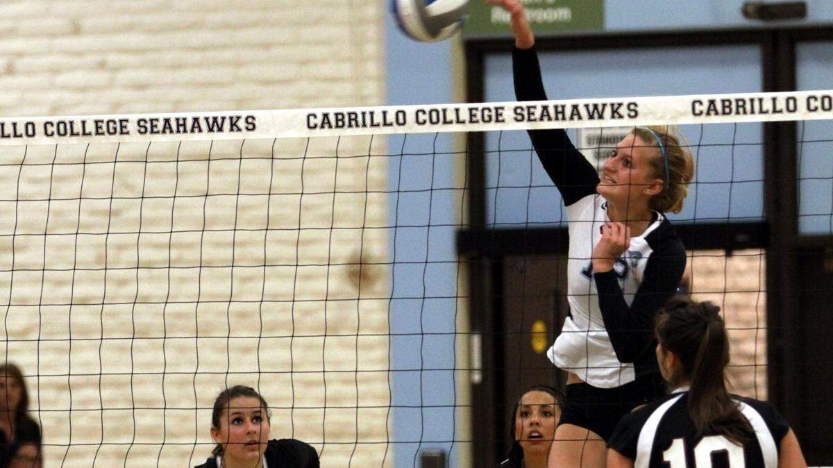 Coast Union High School graduate Skyler Moon in the process of slaming the ball over the net in a game her freshman year at Cabrillo Community College in Santa Cruz.