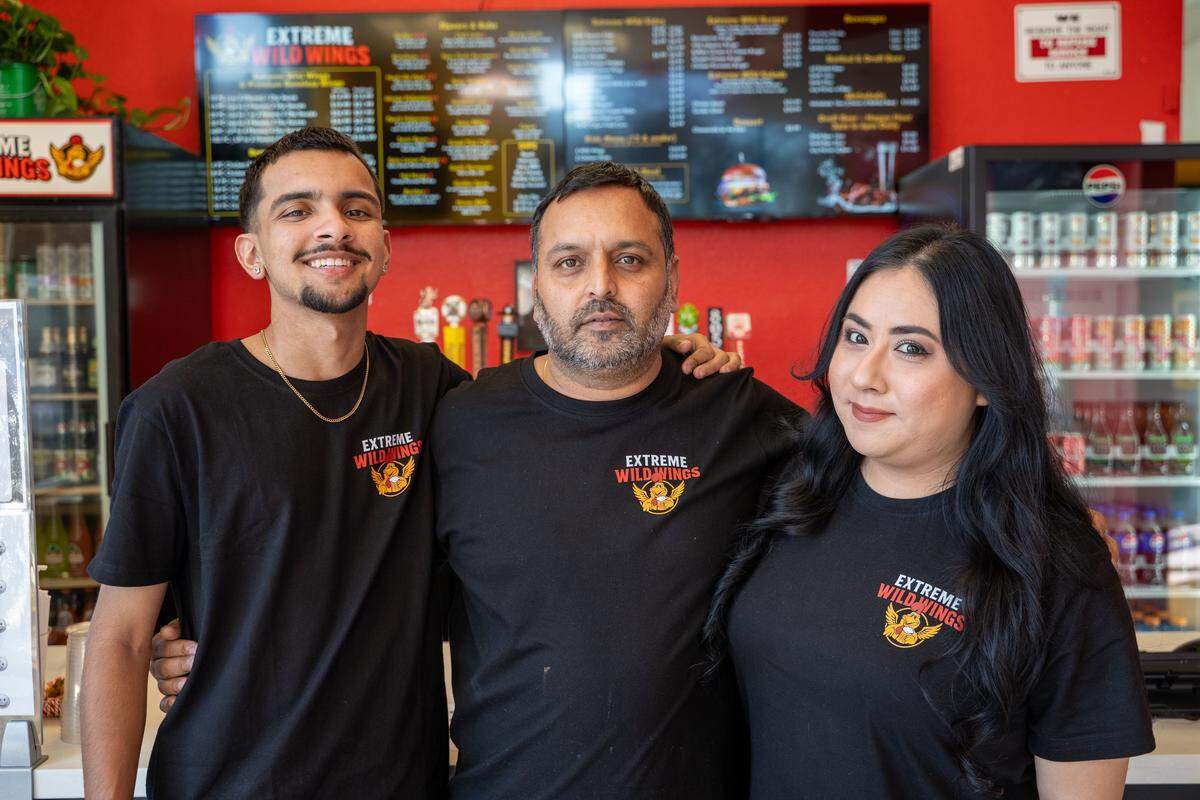Pradan, Hardip and Adriana Virk pose for a photo at Extreme Wild Wings, their new restaurant in Arroyo Grande, on Wednesday, Jan. 7, 2026. A grand opening is planned for late January or early February.