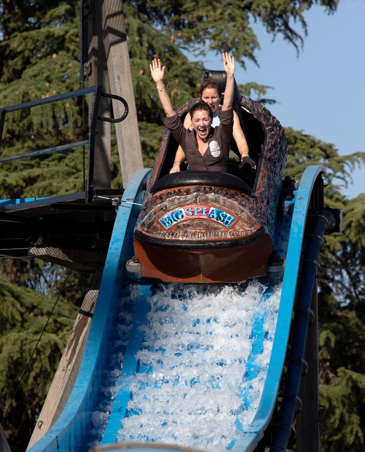 Tribune reporters Chloe Shrager, left, and Kelsey Oliver grin while taking a plunge on the Big Splash ride at the Mid-State Fair on Wednesday, July 17, 2024.