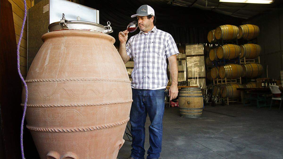 Chris Ferrara of Clesi Wines in San Luis Obispo samples some Nebbiolo wine from his Italian made amphora.