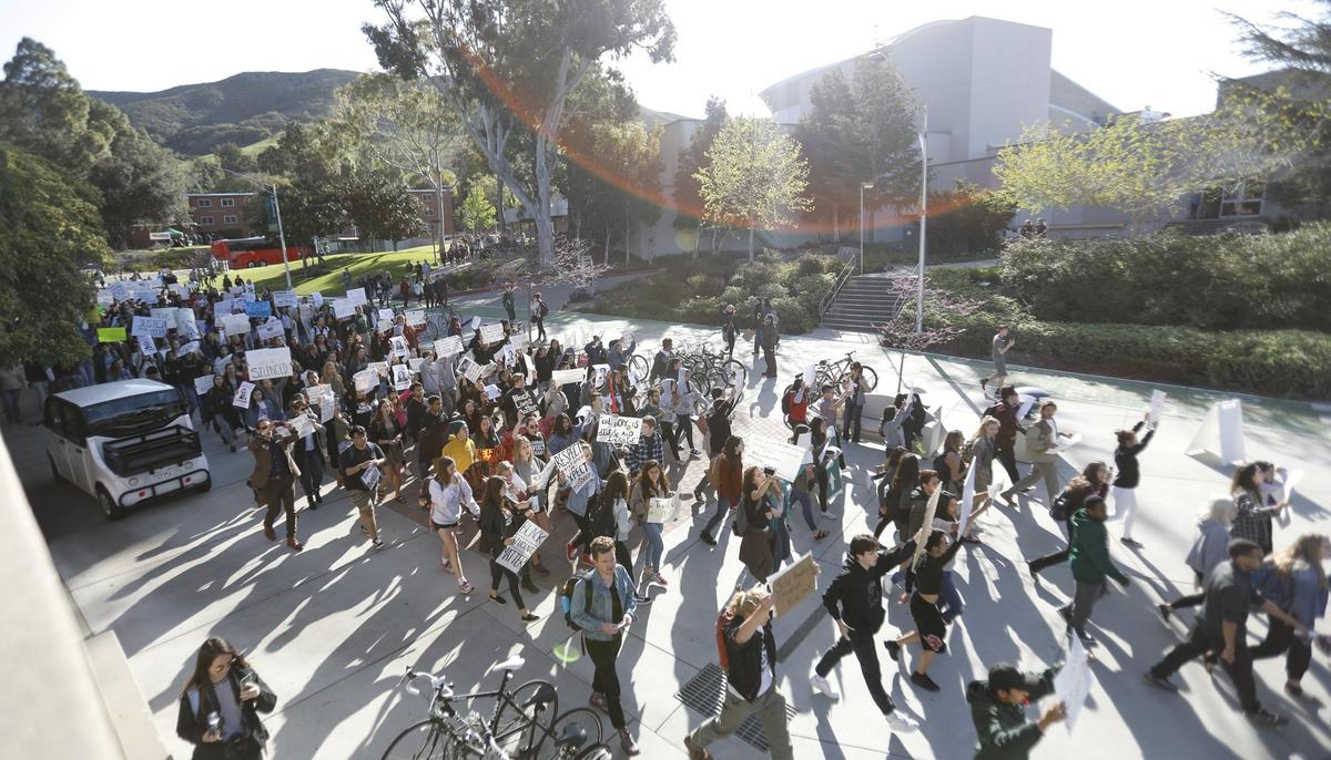 Students marched around campus Friday at the Cal Poly Open House Day of Action protest in response to the fraternity blackface/gangster photos. Students began marching from the parking lot at Slack Street and walked through campus, stopping at the University Union Plaza and the Recreation Center.