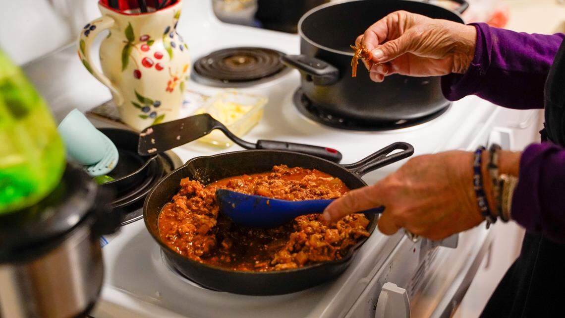 Darlene Maphis, 66, prepares a meal in her apartment at the Templeton Place II affordable housing community on Thursday, Sept. 19, 2024. Maphis said even with affordable housing and some of her expenses covered, she still struggles with San Luis Obispo County’s high cost of living.