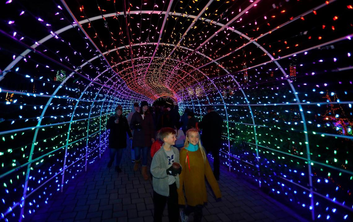 Visitors walk through the Christmas Lighted Tunnel at the Cambria Christmas Market on Wednesday, Dec. 14, 2022.