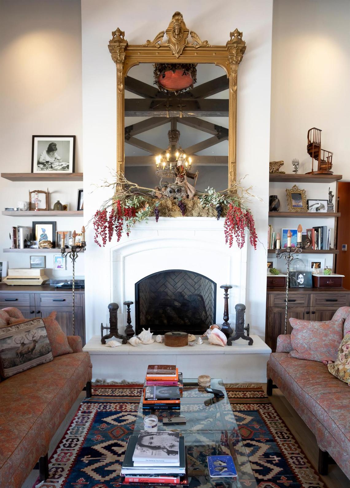 A large gilt mirror that once belonged to the Hotel del Coronado in San Diego hangs above the fireplace in the living room of the San Miguel home of Charles Miller and Tina Gulotta-Miller.