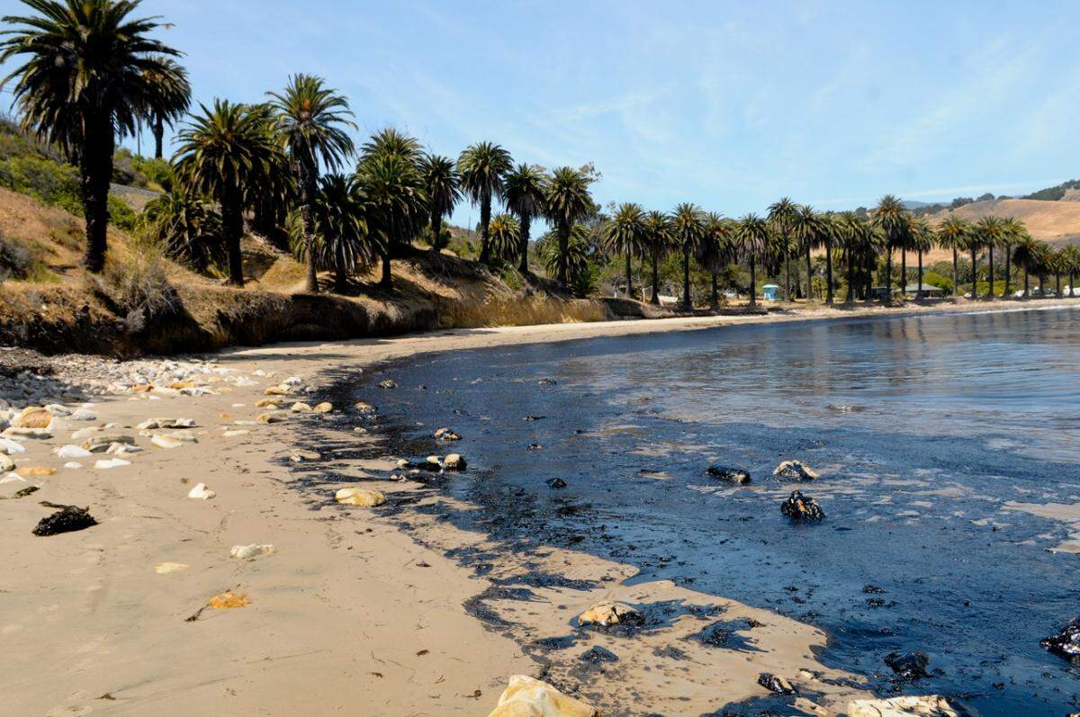 Oil covers the cove at Refugio State Beach on May 19, 2015, after a nearby Plains All American crude oil pipeline burst. The company has agreed to settle a class-action lawsuit and pay $230 million to fishers, fish processors, and shoreline property residents damaged by the spill.
