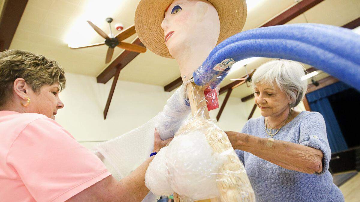 Instructor Michele Sherman, left, and her assistant Sue Oberholtzer work on constructing Sherman's scarecrow "Flash Pants Florence" during a workshop at the Cambria Veterans Memorial Building.