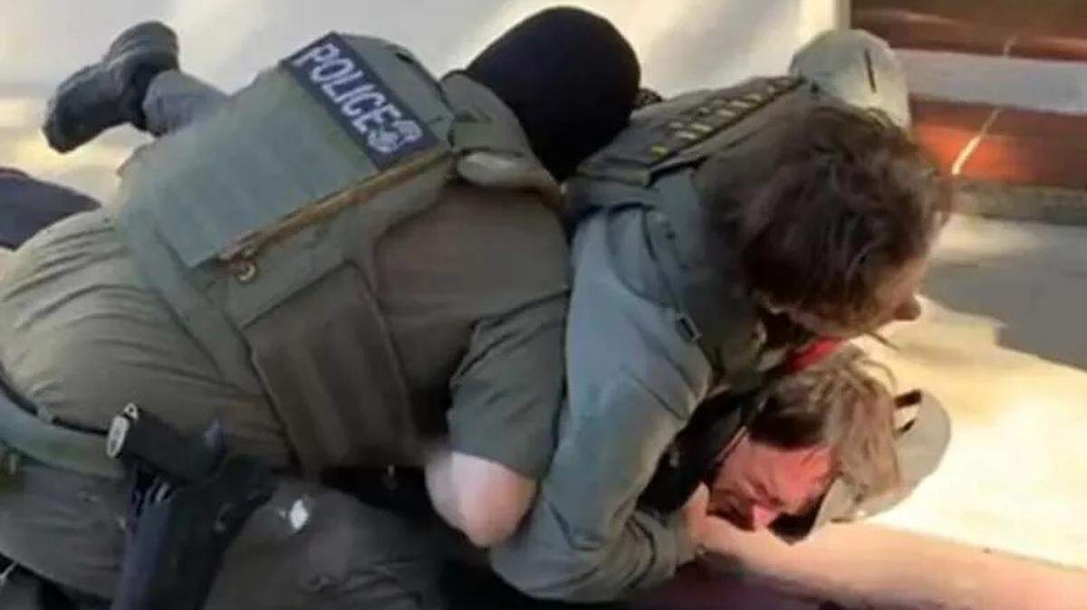 Two ICE agents pin down a Santa Barbara man they accused of vandalizing one of their vehicles on Friday, Feb. 20, 2026. They later detained the man and transported him to an ICE facility. The man, 26-year-old Jack Randmaa, is a United States citizen, his parents told Noozhawk.