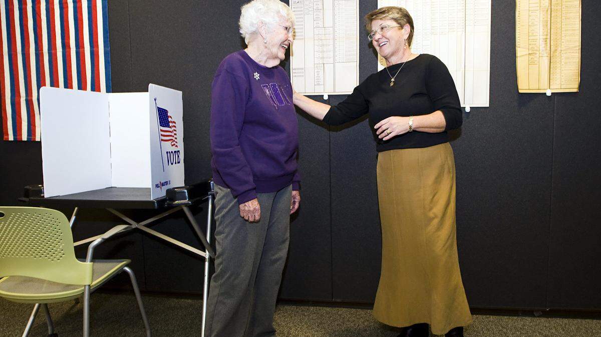 Standing among voting memorabilia retired supervisor Shirley Bianchi, left, shares a laugh with County Clerk-Recorder Julie Rodewald during Rodewald's retirement party Friday.