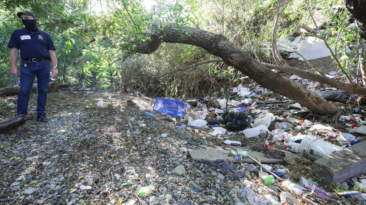 John Klevins, a social worker with the San Luis Obispo Police Department’s Community Action Team, contacted residents at more than 50 camps along the Bob Jones City to the Sea Bike Trail, offering services during a cleanup in October 2020. This camp spills garbage into San Luis Obispo Creek, and Klevins was worried it would send trash downstream.