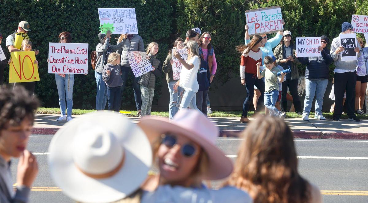 More than 200 people protested against COVID-19 vaccination rules at SLO County schools on Monday, Oct. 18, 2021, outside the Public Health Department, waving placards, ringing cowbells and blowing whistles.