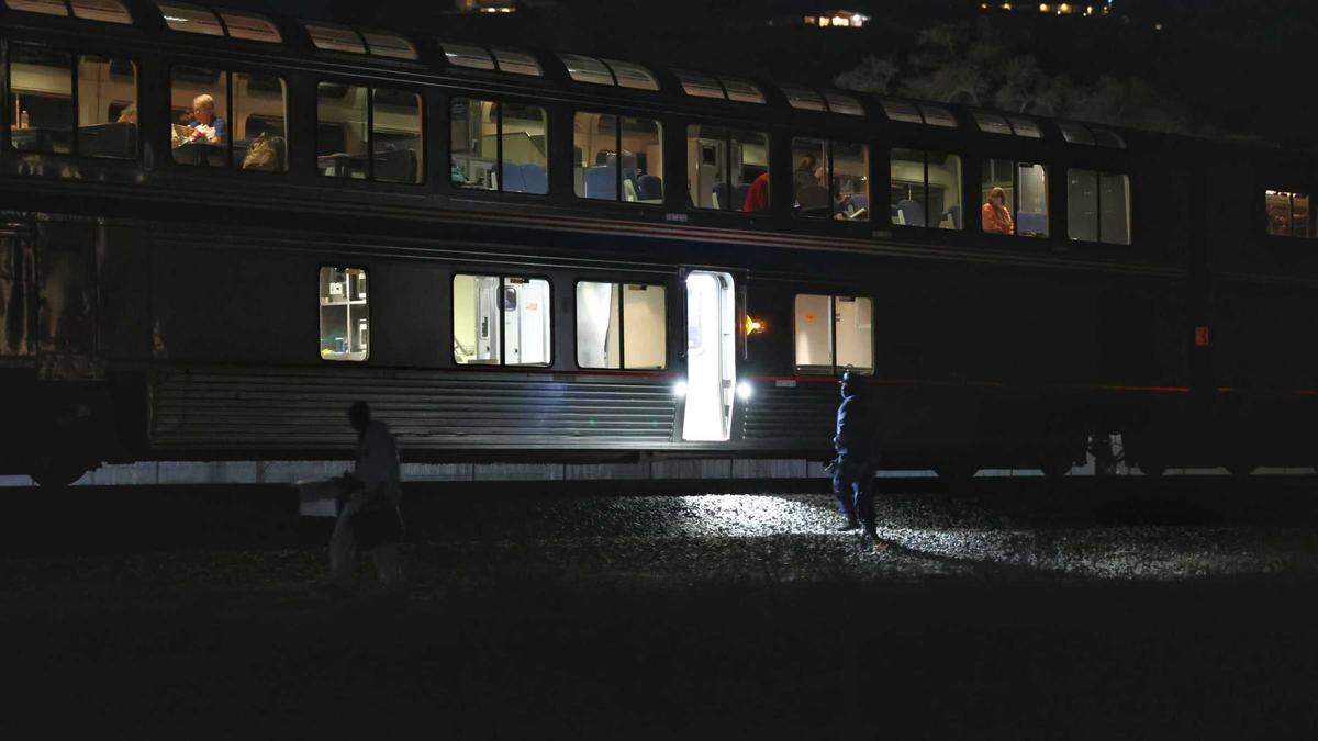 Investigators walk alongside the tracks in Paso Robles at the scene of a fatal train incident.