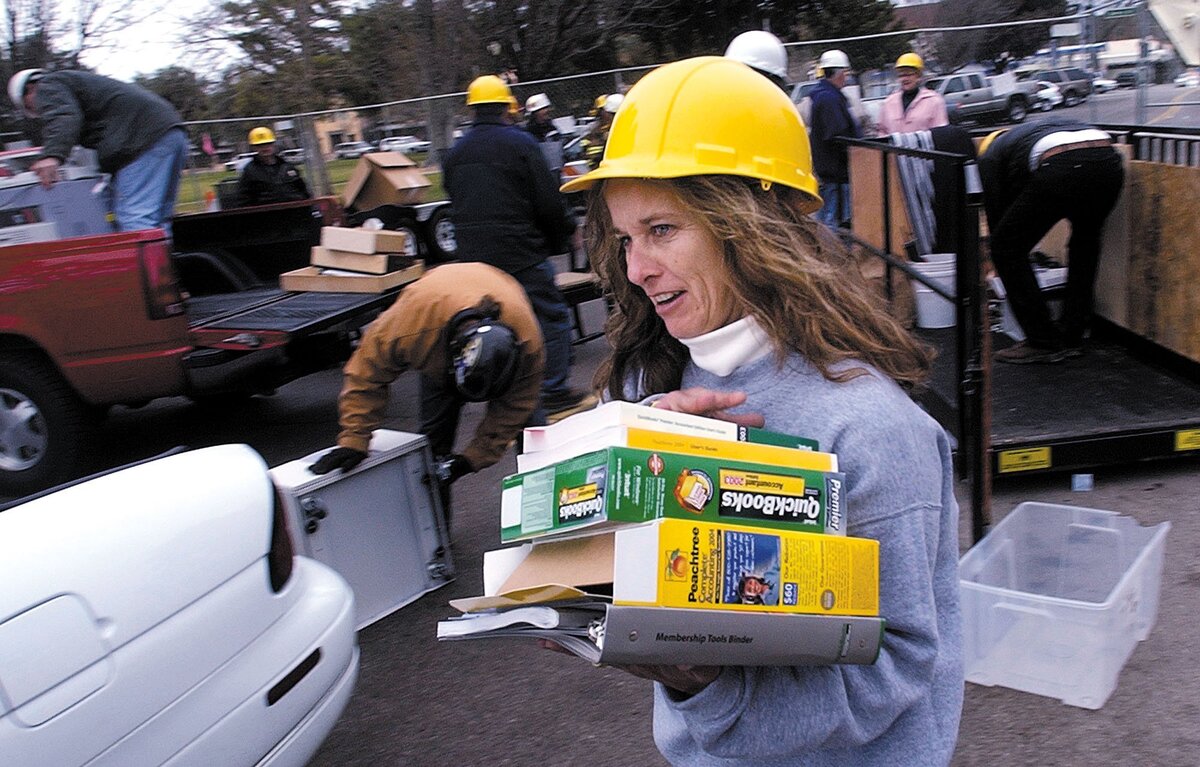 Cindy Esquibel, office manager with the accounting firm of Cassabon McIlhatton, is happy to get their software out of their second floor office in the Marlow building on Jan. 28, 2004. The building was red tagged after the San Simeon Earthquake.