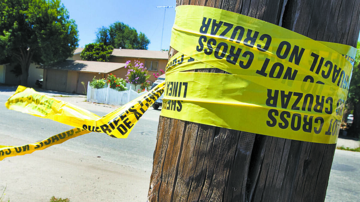 Police tape is still visible days later on a pole across the street from the scene of a double homicide and kidnapping San Ardo in Monterey County.
Photo by Joe Johnston 08-07-12