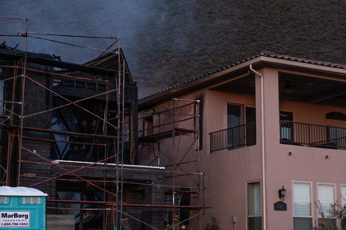 A fire that consumed a house under construction also damaged the homes on either side of the house in Pismo Beach on Tuesday.