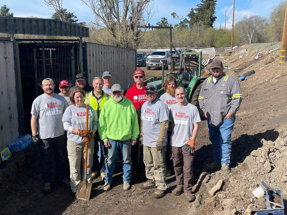 Volunteers cleaning up debris at the Cardoza ranch on Feb. 11, 2023.