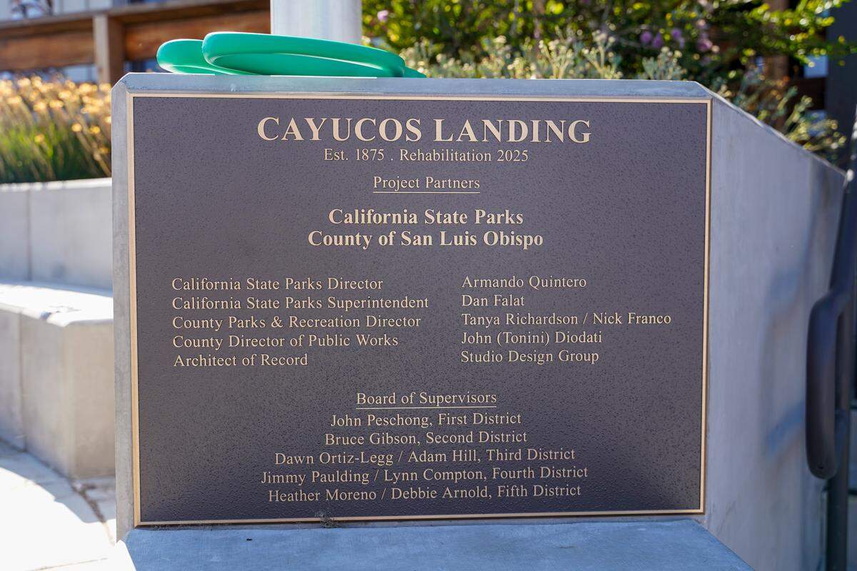 A plaque commemorates the San Luis Obispo County officials responsible for the renovation of Cayucos Landing at the building’s grand re-opening on Monday, Aug. 25, 2025. More than 200 people turned out to see the new Cayucos Landing, which underwent an $11 million rehabilitation project between 2022 and 2025.