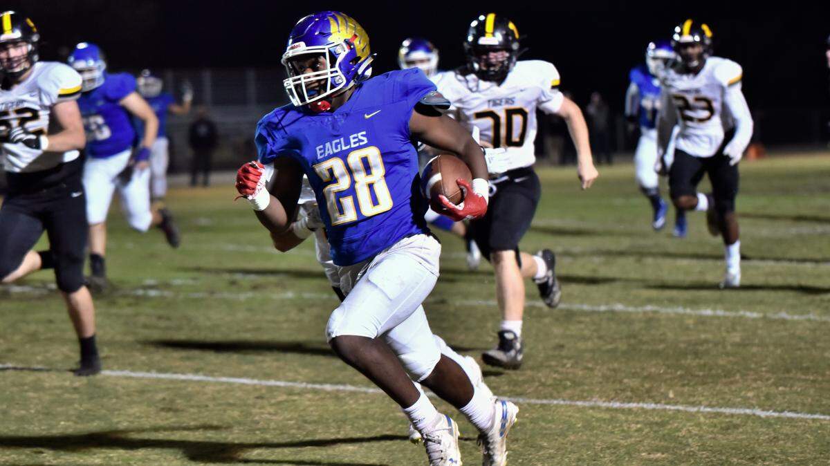 David Stevenson (28) from Bakersfield Christian High School runs for a long gain against San Luis Obispo during a Central Section Division III semifinal playoff game.
